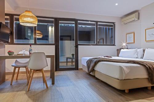 a bedroom with a bed and a desk with a chair at Aparthotel Bcn Montjuic in Barcelona