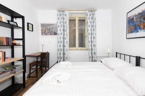 a bedroom with a white bed and a window at Boutique House Anni in Piran