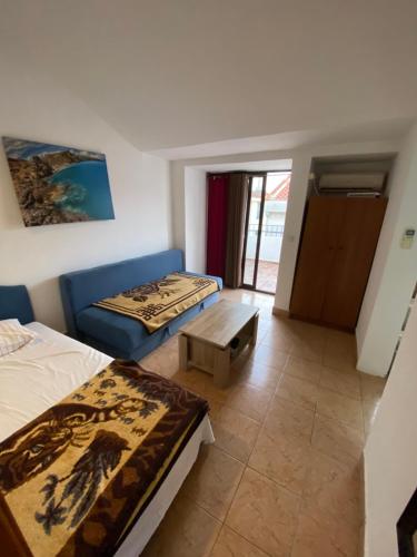 a room with two beds and a table in it at Casa del Mare in Ulcinj