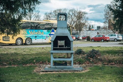 a bird house sitting in the grass next to a bus at Apartments Brunarica in Moravske Toplice