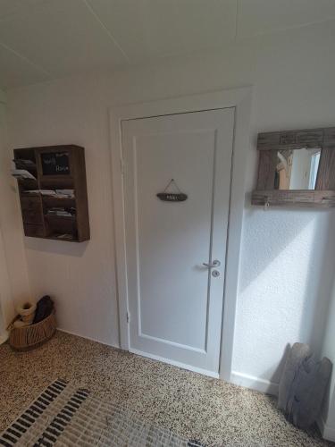 a white door in a room with a shelf at A hidden gem in the woods in Tim