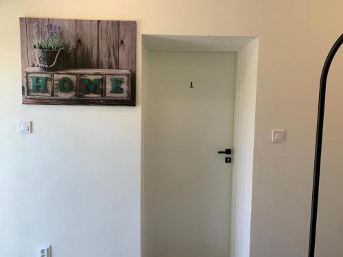 a door with a picture on the wall with a plant at Apartmány 150 in Uherský Ostroh