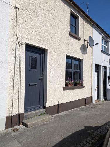 a building with a blue door and a window at Fountain Street in Bessbrook
