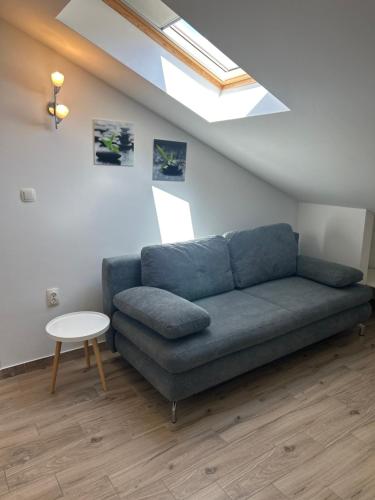 a living room with a blue couch and a table at Apartments Purkovic in Vodice
