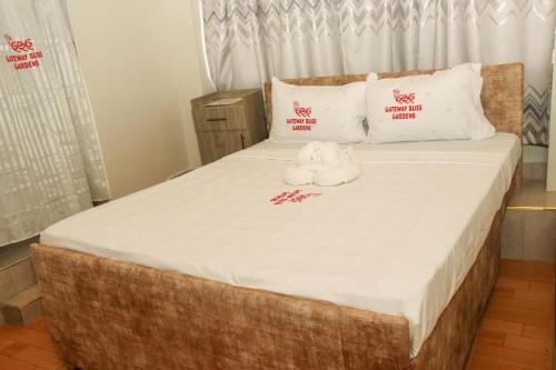 a bed with two stuffed animals sitting on it at Gateway Bliss Gardens in Nairobi