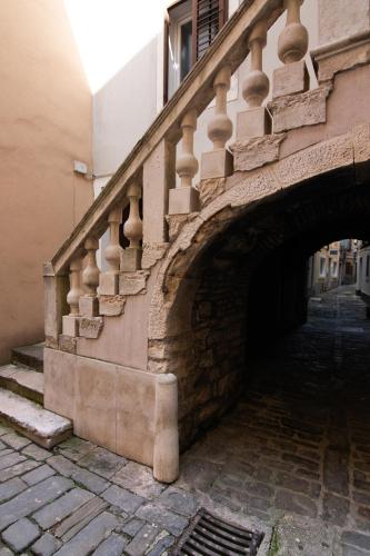a stone staircase on a building next to a tunnel at Boutique House Anni in Piran