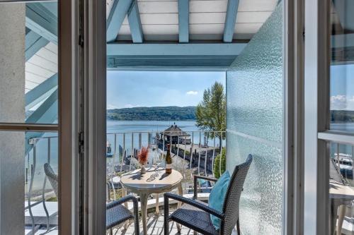 a view from the balcony of a house with a table and chairs at SEE-Hotel Seeschau - direkt am Bodenseeufer in Reichenau