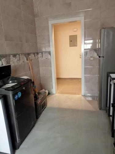 a kitchen with a hallway with a door to a room at White Rose in New cairo