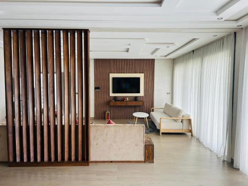 a living room with a couch and a tv at Villa Naouma in Marrakech