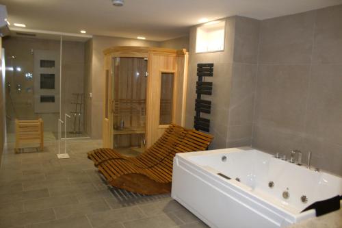 a large bathroom with a tub and a shower at Villa Stesicoro Suite in Mondello