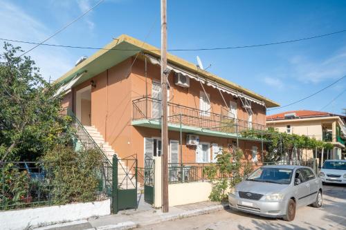 a house with a car parked in front of it at Rooms Grapevine in Póros Kefalonias