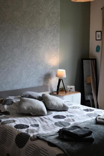 a bedroom with a bed with pillows on it at gite de tounette in Authieule