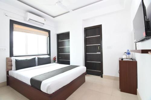 a bedroom with a large bed and a television at Dream Place in New Town