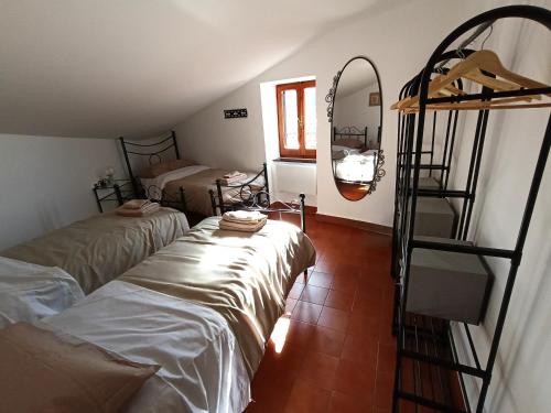 a room with two beds and a ladder in it at La casa dell'arco in Roccasecca dei Volsci