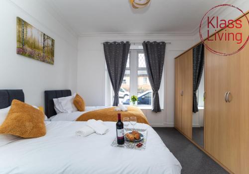 two beds in a room with a mirror at Albion Apartment by Klass Living Coatbridge in Coatbridge