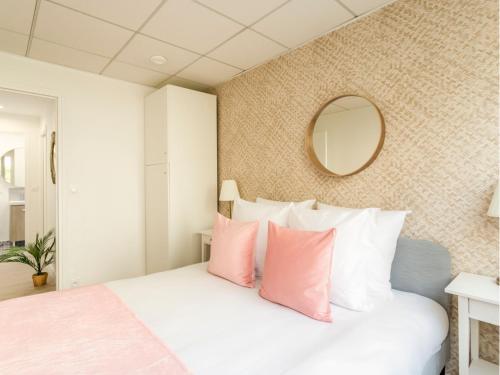 une chambre avec un lit avec des oreillers roses et blancs dans l'établissement Merveil - Family Suite - Tour Eiffel - Viala I, à Paris