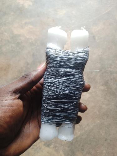 a hand holding a piece of wrapped up object at The Real Powerful Spiritual Herbalist Man In Nigeria in Ijebu Igbo
