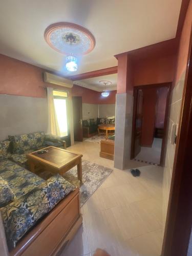 a living room with a couch and a table at اقامة قرب حمام my yaacup in Moulay Yacoub
