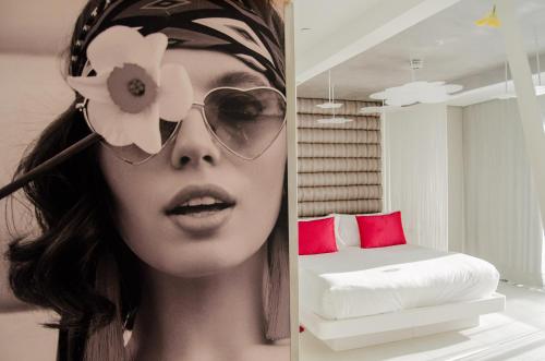 a woman wearing sunglasses and a hat with a flower on her head at Five Flowers Hotel Formentera, member of Melia Collection in Es Pujols