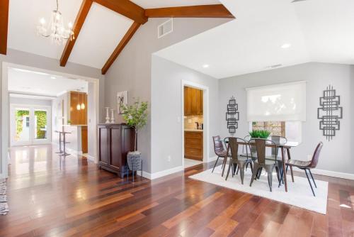 a dining room and living room with a table and chairs at Walk to Ventura Boulevard Pool & HotTub with PingPong & BBQ in Sherman Oaks