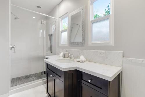 a bathroom with a sink and a shower at Walk to Ventura Boulevard Pool & HotTub with PingPong & BBQ in Sherman Oaks