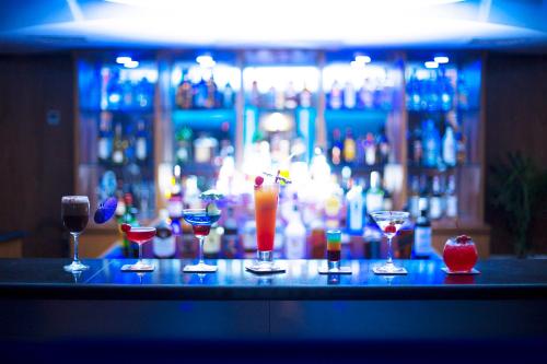 a group of glasses sitting on top of a bar at Hotel 71 in Dhaka