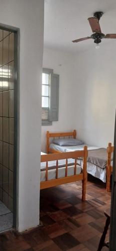 a room with two beds and a ceiling fan at Acacia hotel in Laguna