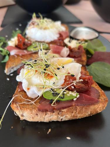 a piece of toast with meat and vegetables on a plate at Penzión Liezky in Mýto pod Ďumbierom