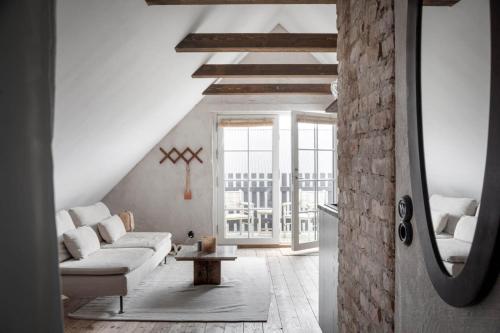 a living room with a couch and a table at Charming loft on Österlen in Tomelilla