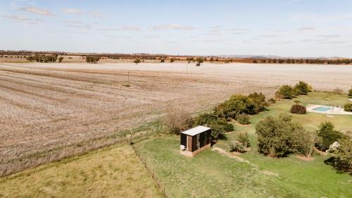 an overhead view of a small building in a field at Tiny Balloon House by Tiny Away in Canowindra