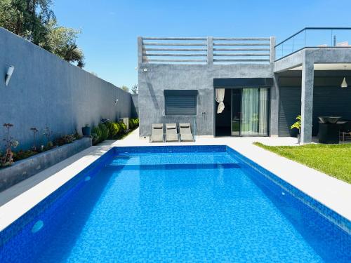 a swimming pool in the backyard of a house at Villa Naouma in Marrakech