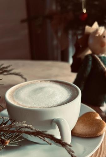a cup of coffee on a plate with a spoon at Penzión Liezky in Mýto pod Ďumbierom