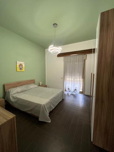 a bedroom with a large bed and a window at La Rosa dello Jonio in Giarre