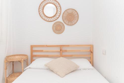 a bedroom with a bed and a mirror on the wall at Alba Azzurra in San Pasquale