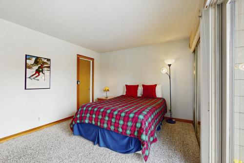 a bedroom with a bed with red pillows at Scott Peak Views in Alpine Meadows