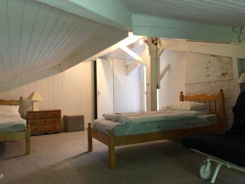 a bedroom with a canopy bed and a chair at Rose cottage in Montcaret