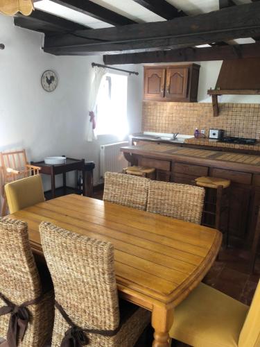 a dining room with a wooden table and chairs at Rose cottage in Montcaret
