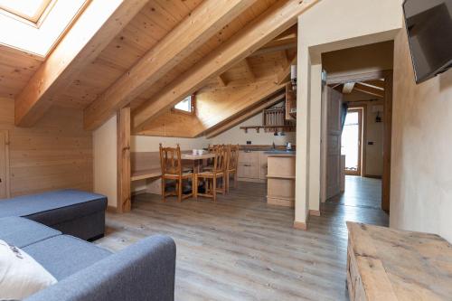 a living room with a couch and a table at Engadina Chalet in Livigno