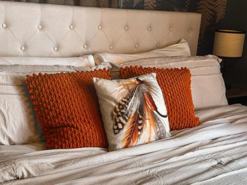 a bed with two orange pillows on it at Condo 2bd2bagrilllaundry-10pp-pet Friendly in Russell