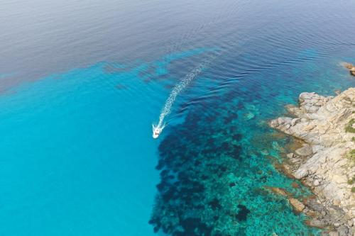 an aerial view of a boat in the ocean at LAVITA Camp - Capitana Villasimius in Capitana