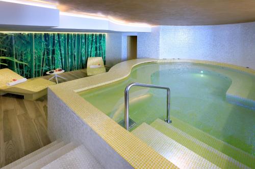 a jacuzzi tub in a hotel room at Five Flowers Hotel Formentera, member of Melia Collection in Es Pujols