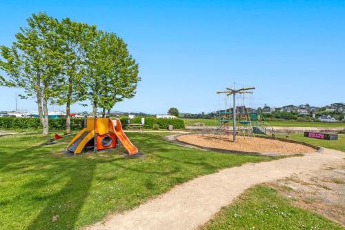a park with a playground with a slide at Les Terrasses de la Palud in Landéda