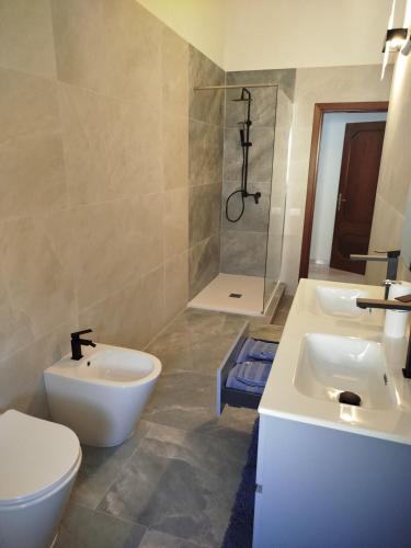 a bathroom with two sinks and a shower at Big Apartment in Assemini