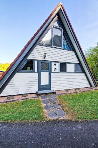 a white house with a gambrel roof at Holiday Home Winnetou by Interhome in Machtlos