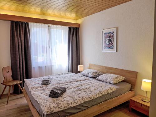 a bedroom with a bed with a bag on it at Apartment Chalet Almis-Bödeli-1 by Interhome in Grindelwald