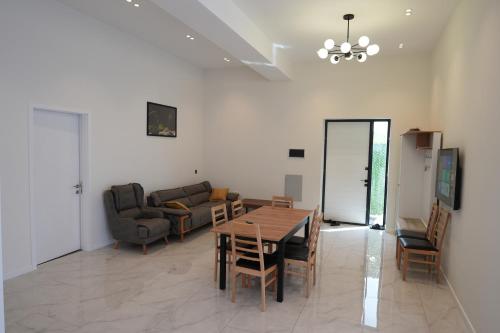 a living room with a table and a couch at White Harmony Houses in Şamaxı