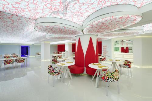 a store with tables and chairs and a ceiling with flowers at Five Flowers Hotel Formentera, member of Melia Collection in Es Pujols