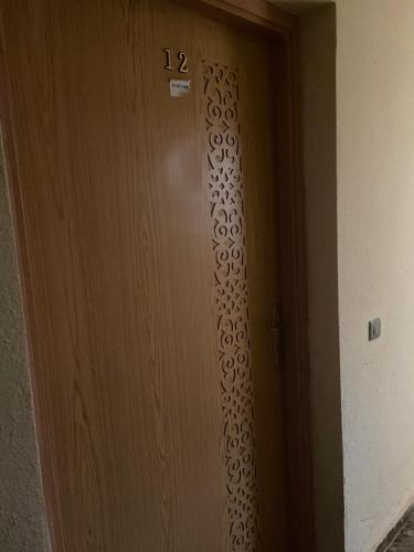 a wooden door with the number on it at Laziza in Temara