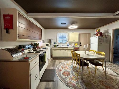 a kitchen with a table and a dining room at Cassio's Cottage in Coudersport