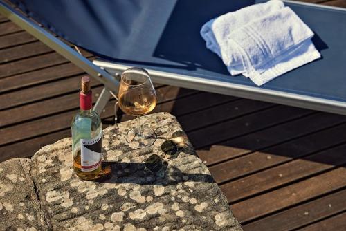 a bottle of wine and a glass sitting on a table at Agriturismo Il Pozzo in Greve in Chianti